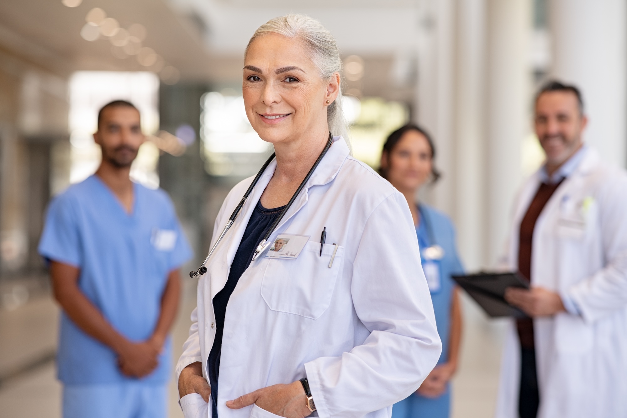 Portrait,Of,Mature,Female,Doctor,On,Hospital,Corridor.,Confident,General